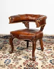  Preview image for An antique brown leather library chair. 