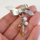  Preview image for SILVER TONE BOW AND DANGLING FAUX PEARLS 